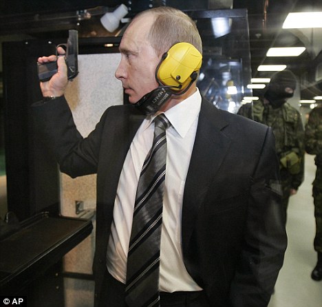 Fire: Putin, seen using a traditional pistol, has new weapons in his sights